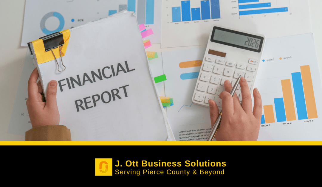 At a desk, one hand holds a financial report while the other is on a calculator.