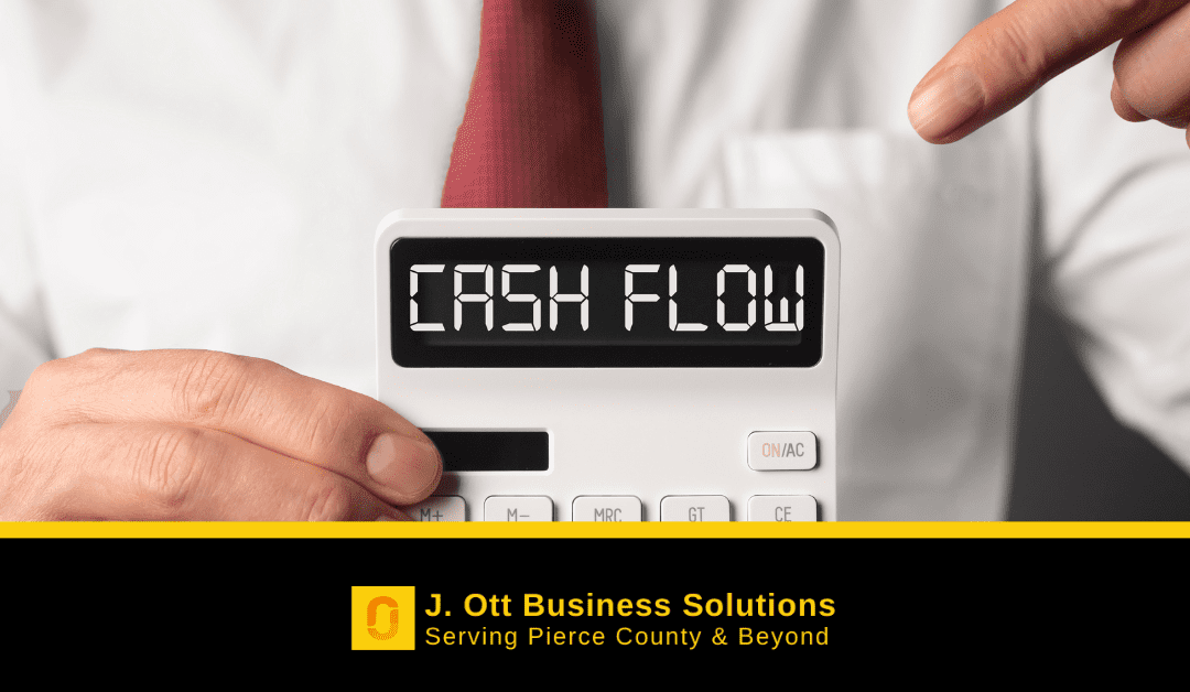 A hand holds a calculator that reads cash flow.