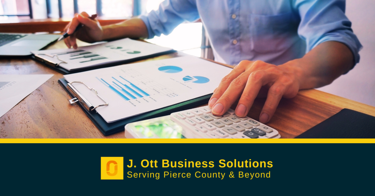 a man sits at a desk bookkeeping.