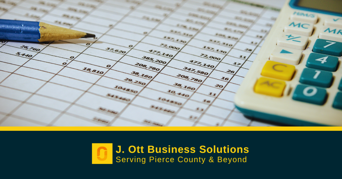 A cash flow balance sheet on a desk near a pencil and calculator.