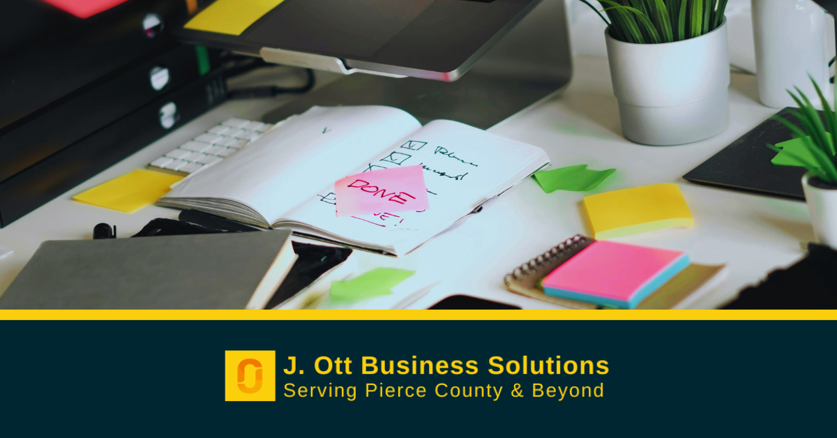 A desk with various items and post-it notes.