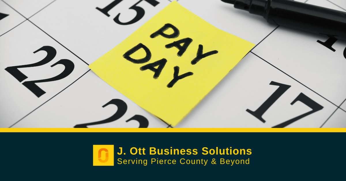 A calendar with a post-it note that reads: Pay Day.