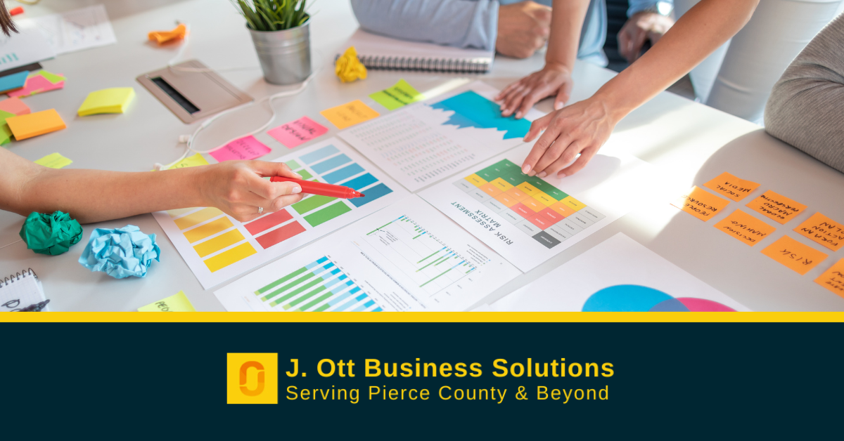 A work group comparing charts for a startup.